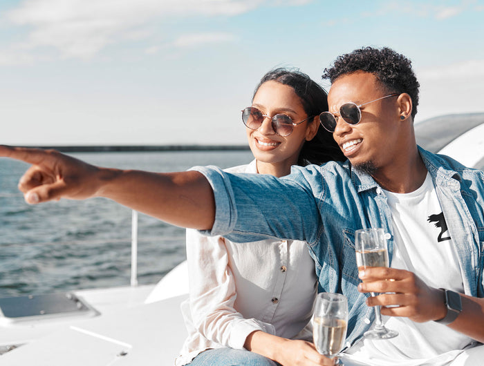 Couple on yacht wearing Harbor Springer logo clothing