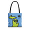 Michigan tote bag with a green Michigan-shaped character wearing sunglasses and smiling and saying "Hi" on a blue background.