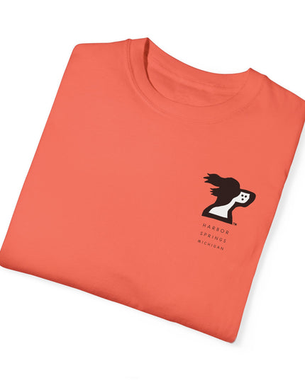 Folded salmon color t-shirt by the Harbor Springer brand with a springer spaniel dog logo and Harbor Springs Michigan text.