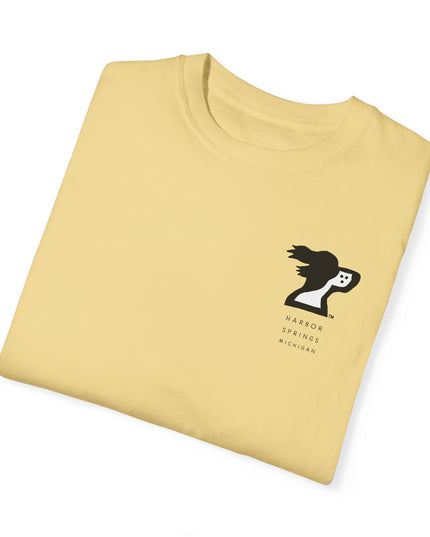 Folded light yellow color t-shirt by the Harbor Springer brand with a springer spaniel dog logo and Harbor Springs Michigan text.