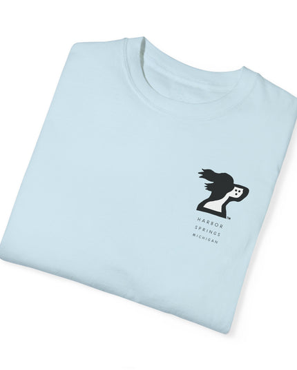 Folded light blue color t-shirt by the Harbor Springer brand with a springer spaniel dog logo and Harbor Springs Michigan text.