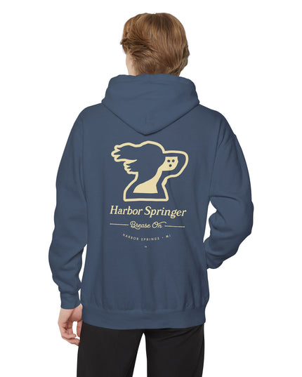 Man wearing blue hoodie by the Harbor Springer brand with a springer spaniel dog logo and Brease On tagline on the back.