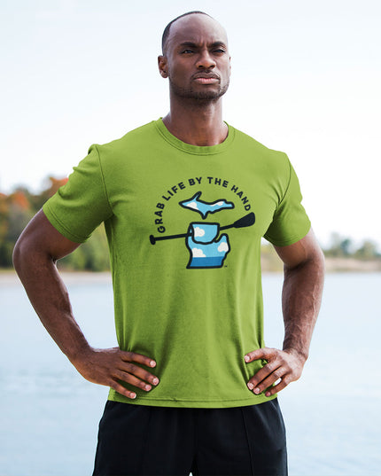 Man wearing a green Michigan t-shirt for people who kayak, canoe or paddleboard, showing the state of Michigan grabbing a paddle with the slogan Grab Life by the Hand™.