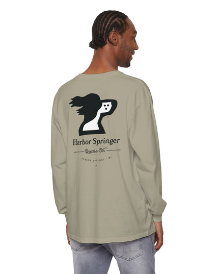 Man standing and wearing a tan long sleeve t-shirt by the Harbor Springer brand with a springer spaniel dog logo and Brease On tagline on the back.