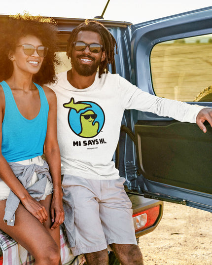 Man wearing cotton long sleeve white t-shirt with a waving Michigan logo wearing sunglasses and smiling for the MI Says Hi brand.