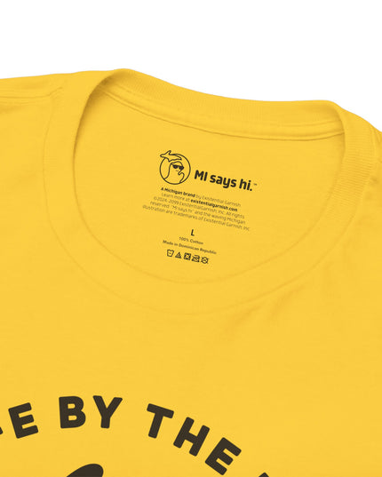 Closeup of neck label of a yellow Michigan tee for people who kayak, canoe or paddleboard, showing the state of Michigan grabbing a paddle with the headline Grab Life by the Hand™.