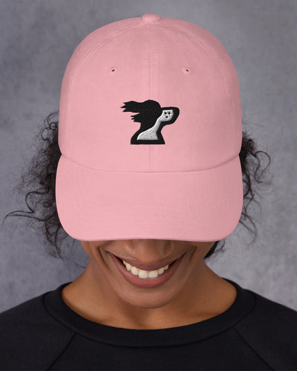 Woman wearing pink dad hat with brand logo by the Harbor Springer brand.