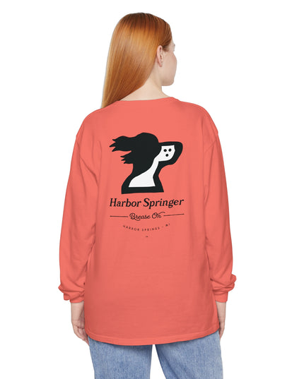 Woman wearing a salmon color long sleeve t-shirt by the Harbor Springer brand with a springer spaniel dog logo and Brease On tagline on the back.