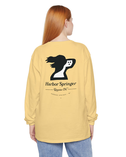 Woman wearing a light yellow long sleeve t-shirt by the Harbor Springer brand with a springer spaniel dog logo and Brease On tagline on the back.