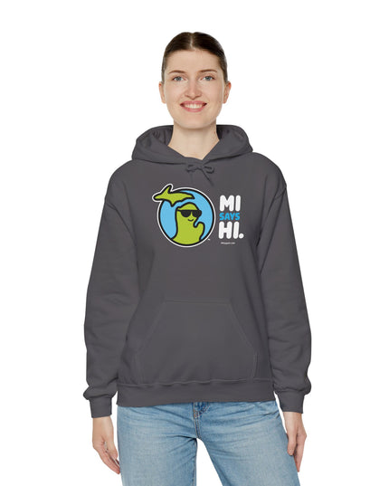 Woman wearing a gray hoodie with waving Michigan logo wearing sunglasses and smiling for the MI Says Hi brand.