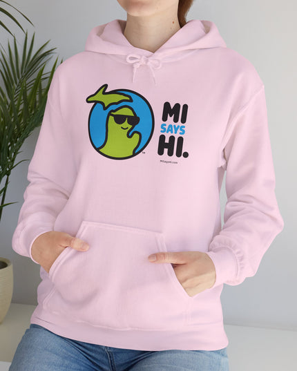 Woman wearing a pink hoodie with waving Michigan logo wearing sunglasses and smiling for the MI Says Hi brand.