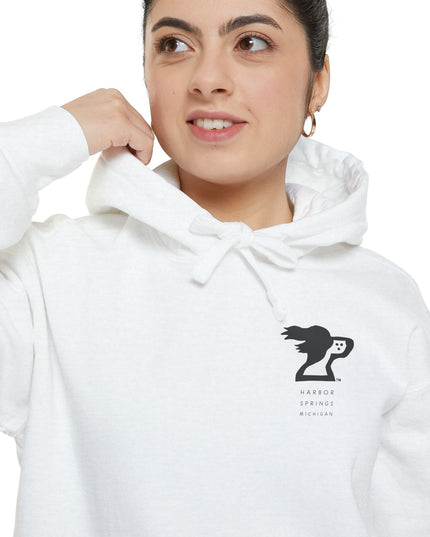 Woman wearing white color hoodie by the Harbor Springer brand with a springer spaniel dog logo and Harbor Springs Michigan text.