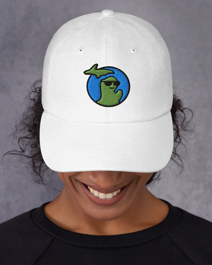 Woman wearing a white hat with a waving Michigan logo embroidered on the front.