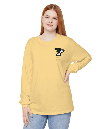 Woman standing nand wearing a light yellow color long sleeve t-shirt by the Harbor Springer brand with a springer spaniel dog logo and Harbor Springs Michigan text.